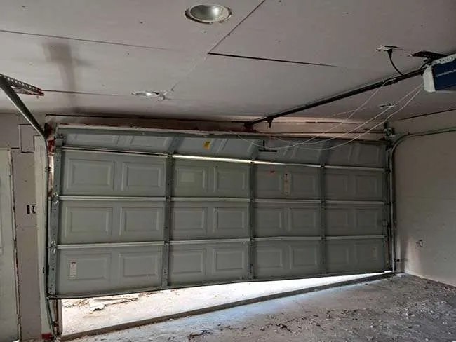 echnician repairing an off-track garage door in Weston Nj